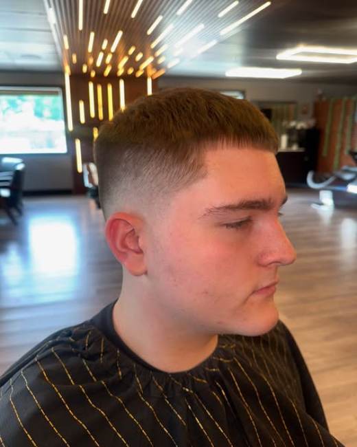 Mid fade haircut with textured top at X-Ecutive Barbershop in North Easton, MA